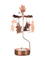 The Candle Holder: Moomin Family Rose Color Pluto Design is a rotary candle holder featuring Moomin characters that gently spin above a Christmas tea light, casting whimsical shadows as it rotates.