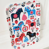The Swedish Dala Horse Birch-Wood Tray (approx. 8x10.5 inches) is made in Sweden and features blue, red, and pink horse illustrations with flowers and berries on a white background.