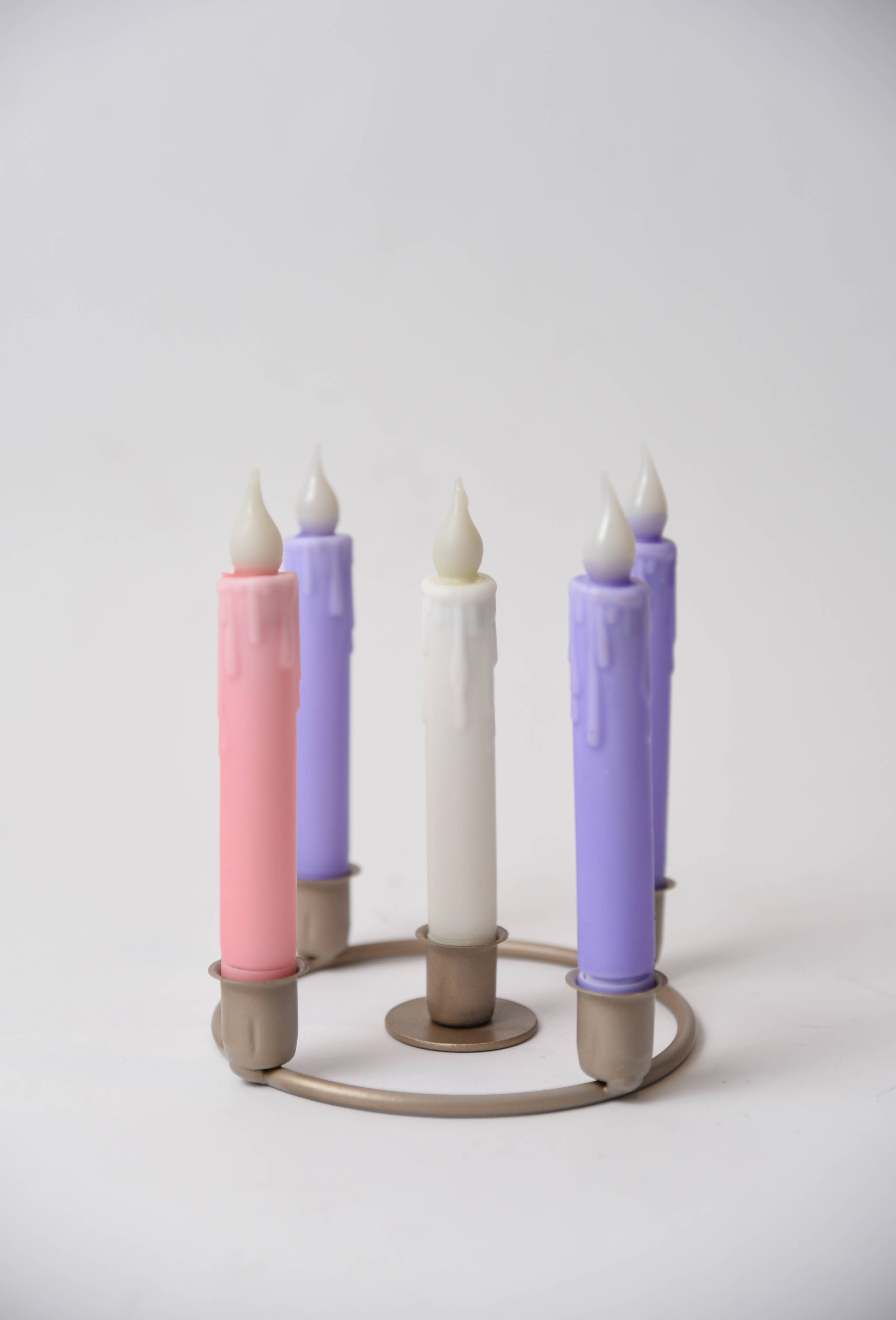 The Candle Holder with Candles: Advent Candle Set w/Holders LED Timer Tapers features five pastel LED tapers (2 purple, 1 white, 2 pink) arranged upright in a circular holder—a charming addition to any space.