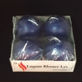 A pack of four navy 2.5" ball candles in a box labeled Lagun Kloster Lys, crafted from natural wax and wrapped in clear plastic, perfectly capturing the essence of Denmark's renowned candle-making tradition with sustainability at its core.