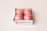 The Logum Kloster Lys 2.5 Ball Candles (4 Pack) features four round pink candles, made in Denmark, wrapped in plastic and labeled for a touch of HYGGE—perfect for cozy decor. Shown against a white background.