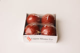 A 4-pack of Logum Kloster Lys 2.5 red ball candles from Denmark, wrapped in plastic, displayed on a white background.