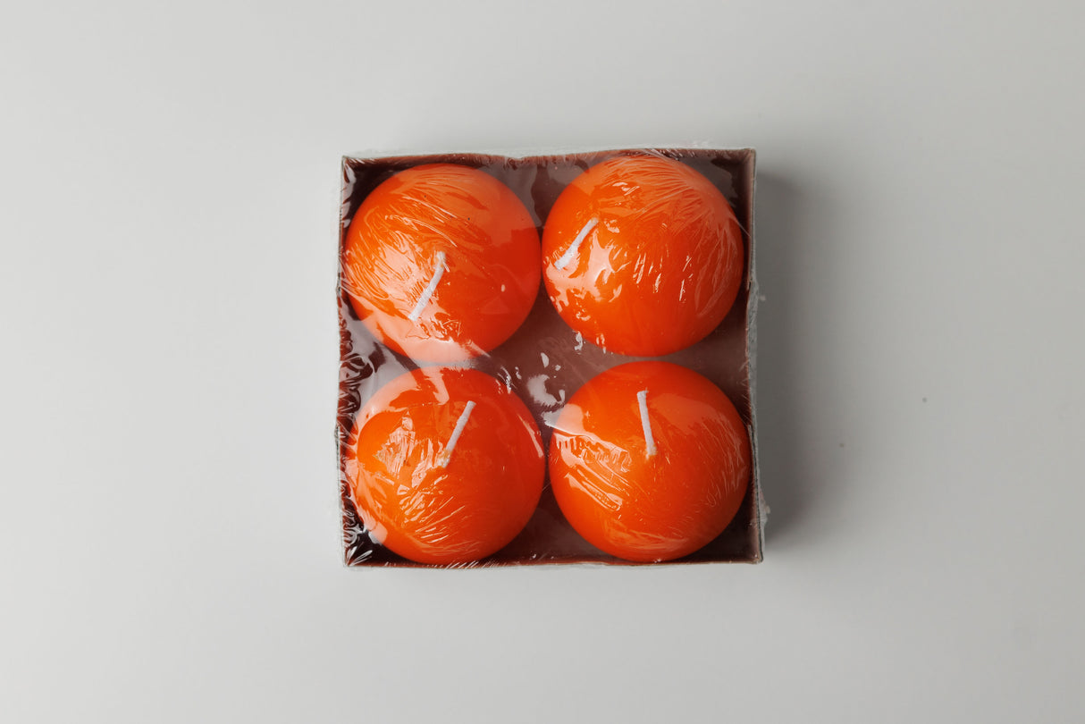 A set of four 2.5" Logum Kloster Lys ball candles by Talla Imports comes in a square box, each orange candle individually wrapped—ideal hygge accents for cozy spaces.
