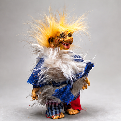The Marketplace24 Troll: Eirik Snowwhisk Troll Witch stands 8" tall, featuring wild yellow hair, a fluffy gray collar, and playful mismatched blue, red, and plaid attire—an ideal handcrafted touch for Nordic home décor.