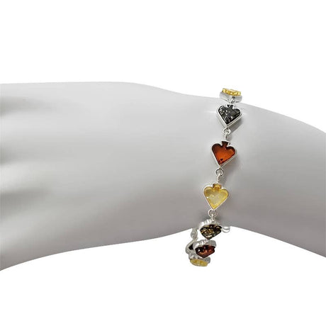 The Bracelet: Multi-Color Baltic Amber .925 Silver Spade Link Bracelet, 7.5" long, features vibrant amber stones and is elegantly shown on a white mannequin wrist.