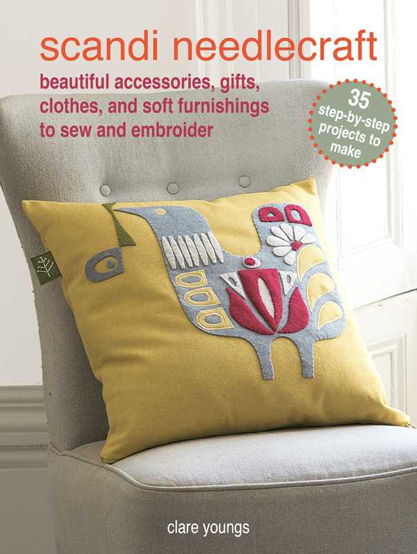 A yellow cushion with a stylized bird, echoing Scandinavian design, rests on a grey chair; above is the book Scandi Needlecraft: 35 step-by-step projects to make by Clare Youngs, paperback, 128 pages.