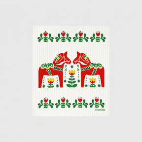 Swedish dishcloth with two red Dala horses surrounded by floral folk art patterns in red, green, and yellow.