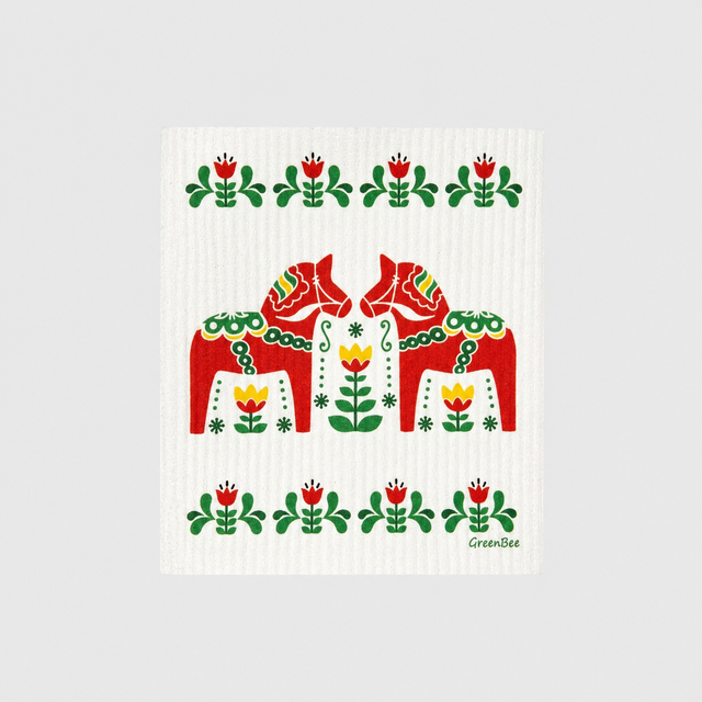 Swedish dishcloth with two red Dala horses surrounded by floral folk art patterns in red, green, and yellow.