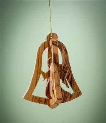 The 3-inch 3D Bell with Angel ornament, crafted from olive wood by skilled Christian artisans in Bethlehem, hangs gracefully against a green background.