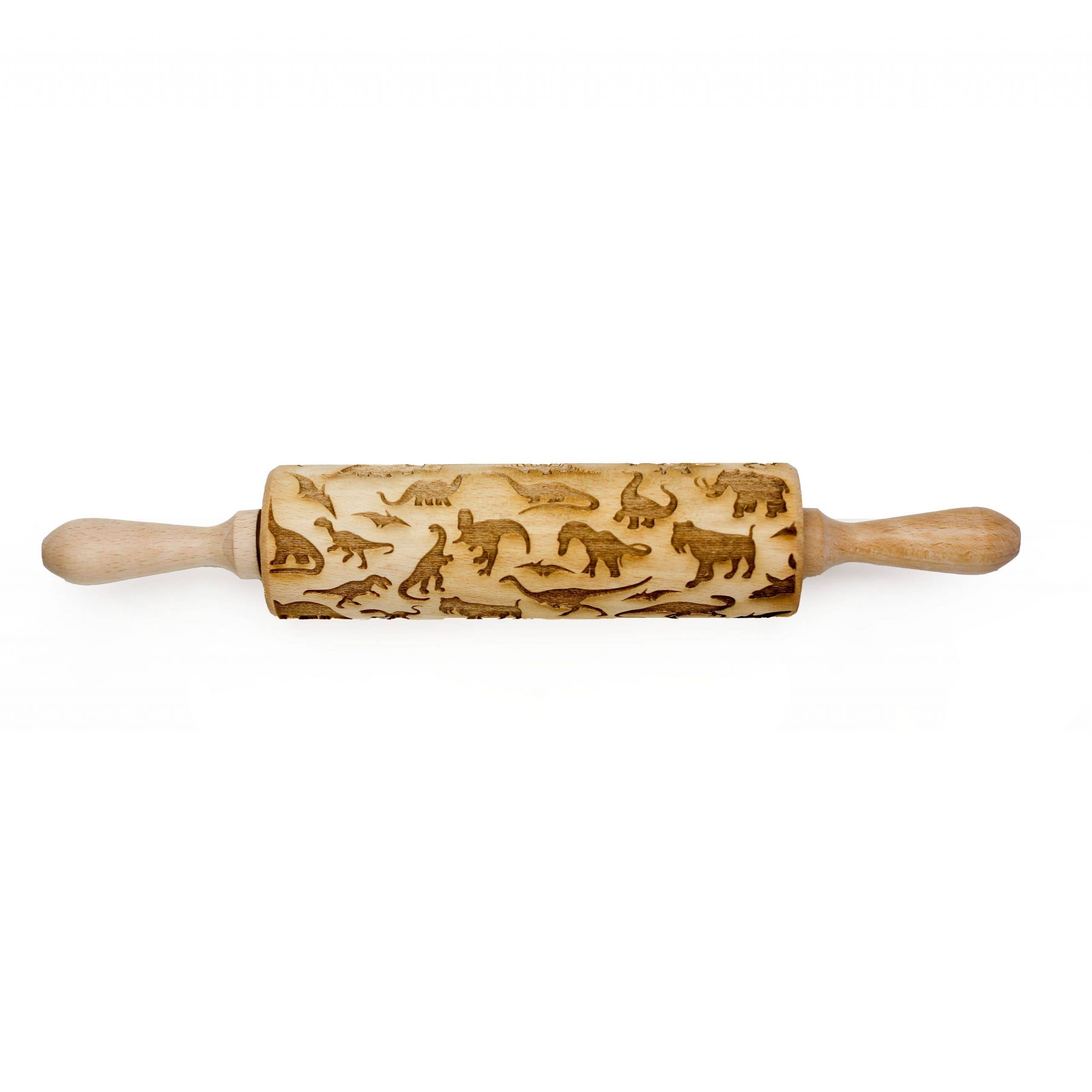 A handmade wooden rolling pin, laser engraved with various animals and featuring delightful dinosaur embossing, is named the Rolling Pin: Dinosaur 1 Embossing Rolling Pin.