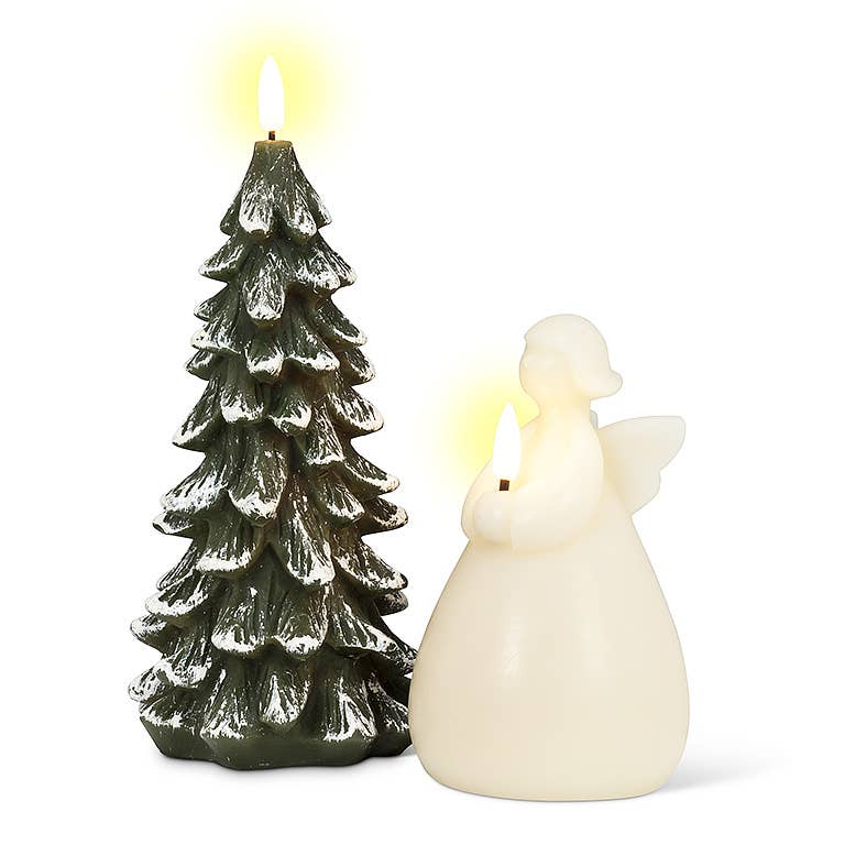 In a tranquil holiday atmosphere, the Snowy Tree LED Candle, standing 9 inches high and resembling a snow-covered tree, emanates a gentle glow next to an angelic figure with its own flickering flame.