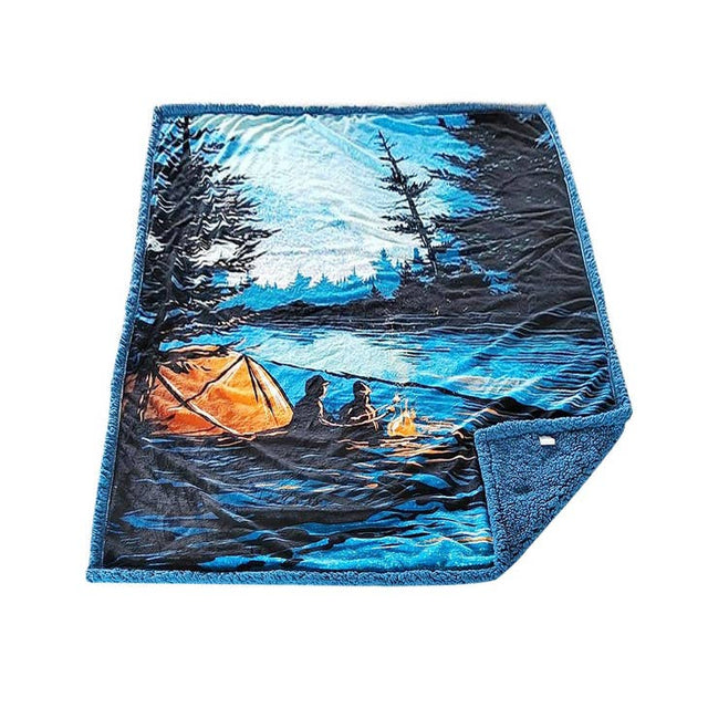 The S'mores Fleece Blanket by Adam Turman features an outdoor scene with two people, a tent, and a campfire by a lake among trees in blue and orange tones, evoking the Minnesota wilderness.