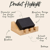 Black bar of soap on a slatted bamboo soap holder with raised edges.