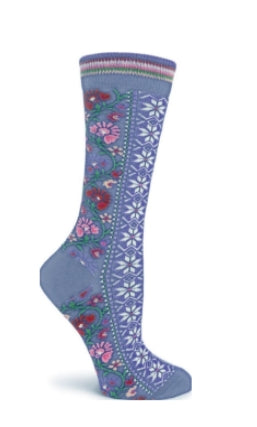 The Ozone Floral Ribbons Blue sock for women is made from fair trade cotton and features blue fabric with white geometric patterns and pink floral designs on the sides.