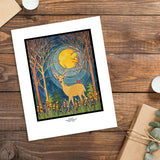 Artwork titled "Deer" by Sarah Angst, a giclee print portraying a deer with antlers and a bird on its back in a forest beneath a full moon. The scene is enclosed by bare trees and wildflowers, created using high-quality pigmented inks.