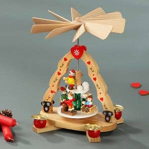 Handcrafted in Germany, the "Kids" Pyramid Candle Holder (7"x6") holds 4 candles and features painted figures, a spinning fan, and heart motifs—a charming wooden Christmas decoration for your home.