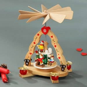 The "Christmas Pyramid: Kids" is a delightful wooden holiday decoration, featuring small traditional figurines and candles on its circular base, with a charming windmill topper that enhances the magic of classic holiday celebrations.