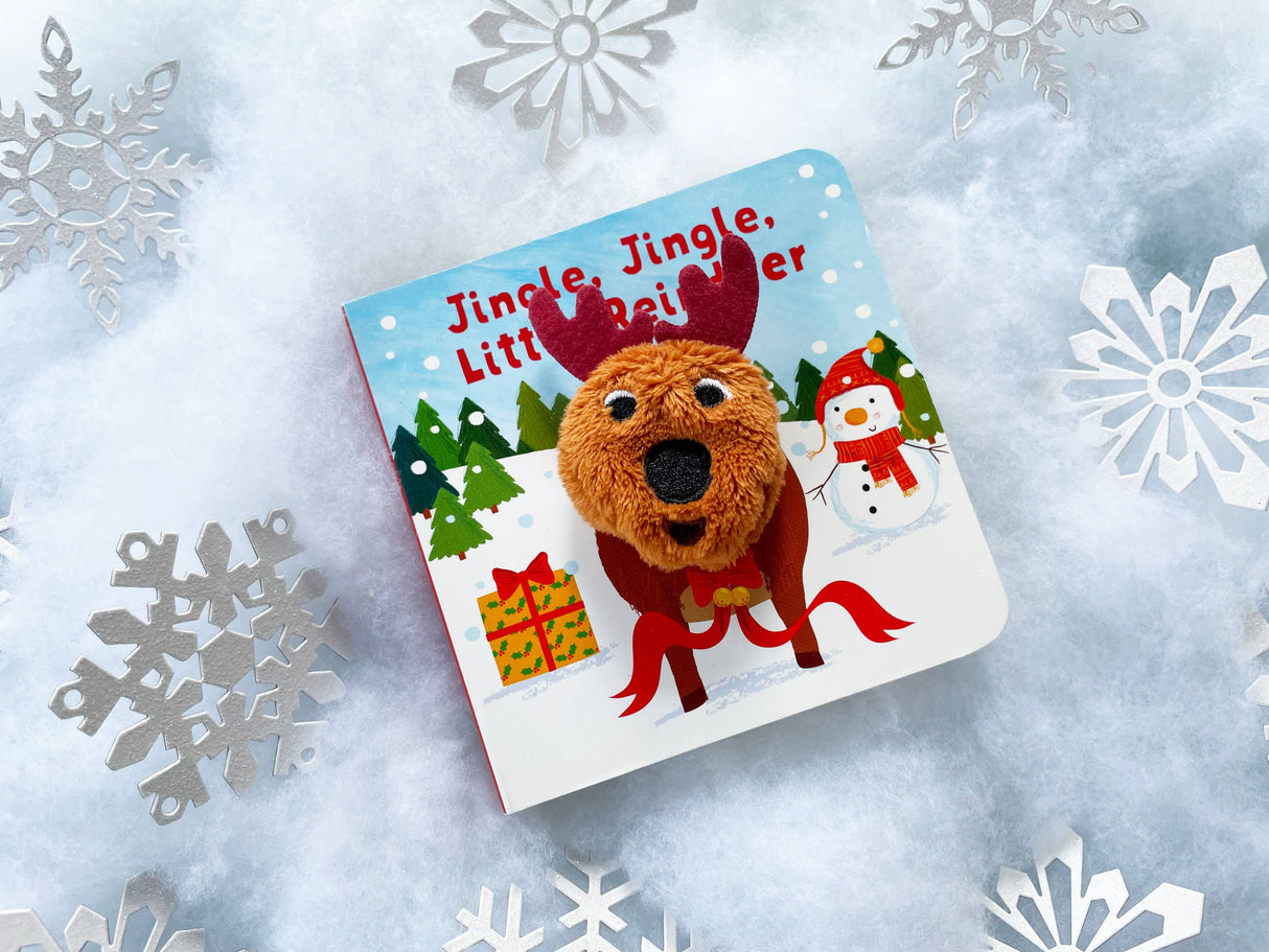 The “Jingle, Jingle, Little Reindeer Finger Puppet Board Book” features a plush reindeer face on the cover, set against a snowy background with silver snowflakes—a festive Christmas board book for babies.