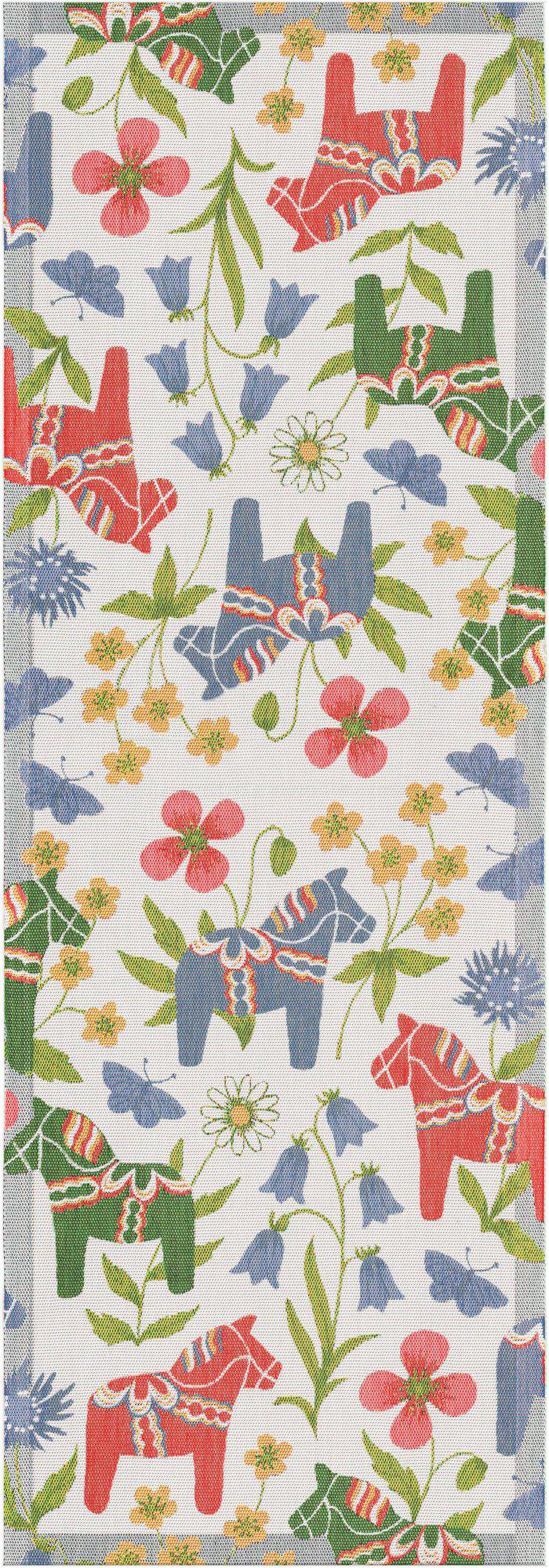 The Blomsterhast Flower Horse Table Runner by Ekelund Master Weavers features red and blue Swedish Dala Horses, green leaves, and colorful flowers on a white organic cotton background.