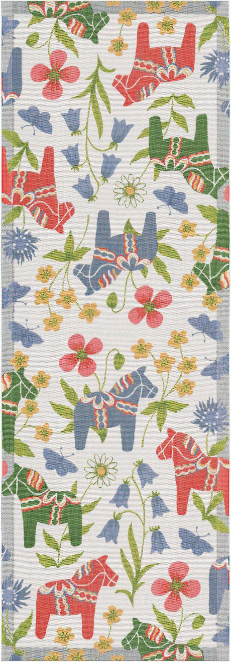 The "Blomsterhast" Flower Horse Table Runner by Ekelund is a rectangular organic cotton runner with red and blue Swedish Dala horses, green leaves, and colorful flowers on a white background.