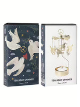 A rotary candle holder with hanging dove charms displayed next to its dark blue and white Scandinavian-style packaging.