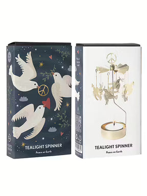 A rotary candle holder with hanging dove charms displayed next to its dark blue and white Scandinavian-style packaging.