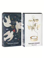 A rotary candle holder with hanging dove charms displayed next to its dark blue and white Scandinavian-style packaging.