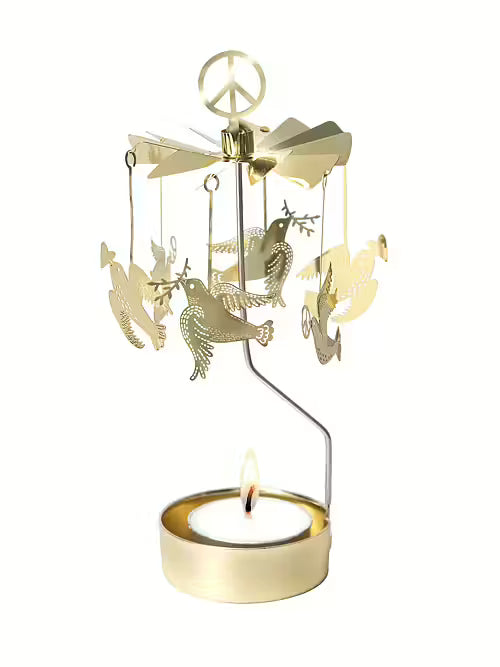 Gold-toned metal rotary candle carousel in a Scandinavian style, featuring hanging doves, a peace sign topper, and a lit tea light candle.