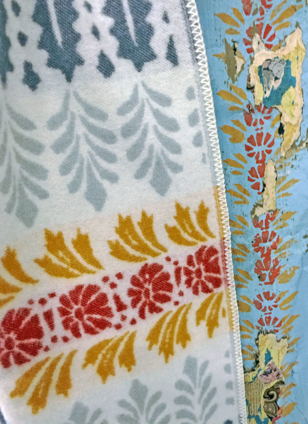 Close-up of the vibrant Arvet Heritage Blanket by Kerstin Landstrom, featuring blue, white, red, and yellow floral motifs in 100% Norwegian Lambs Wool.