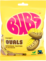A 90g bag of Faire - Stock Boy Candy: Bubs Foam Banana Toffee Ovals vegan gummy candy. The yellow and pink packaging features oval banana toffees and displays vegan and Fairtrade logos in the bottom right corner.