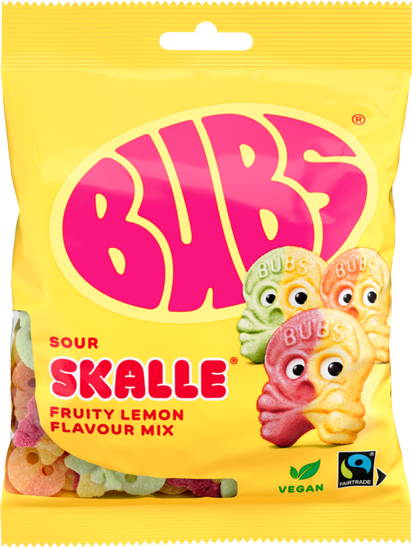 A yellow 90g bag of Faire - Sweet as Fudge Candy: Bubs Sour Foam Fruity Lemon Skulls shows three cartoon lemon skull gummies, vegan and Fairtrade logos, pink BUBS branding, and Scandinavian candy pieces visible through the packaging.