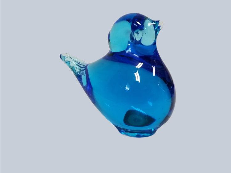 Introducing the beautifully handcrafted Figurine: Baby Bird Swedish Blown Glass Blue 1.25", an exquisite piece showcasing a sleek and smooth surface against a simple backdrop.