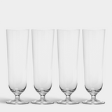 Four empty Orrefors Beer Pils 15.5oz glasses (4-Pack by Erika Lagerbielke) are lined up side by side on a white background.