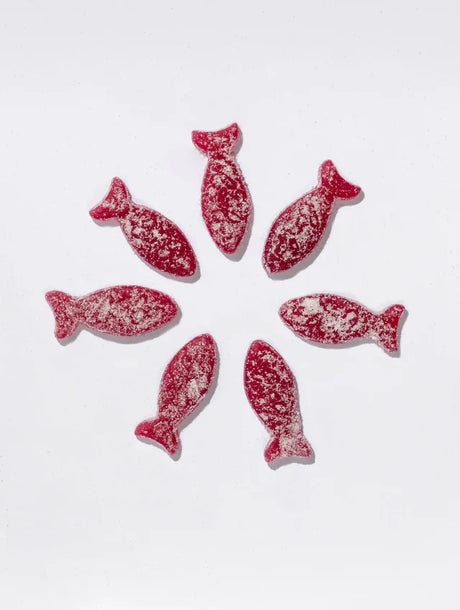 Seven BonBon Sour gummies from the Ultimate Swedish Fish Reimagined 4-Pack are arranged in a circle on a white background.