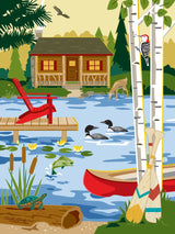 Puzzle featuring a lakeside cabin, ducks, deer, woodpecker, turtle, fish, canoe with paddles, red chair on dock, and birch trees in the background.
