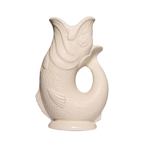 The Gluggle Jug: Gluggle Jug Classic Made in Europe is a white ceramic jug shaped like an upright fish, with its curved tail forming the handle—a timeless piece of British tableware.