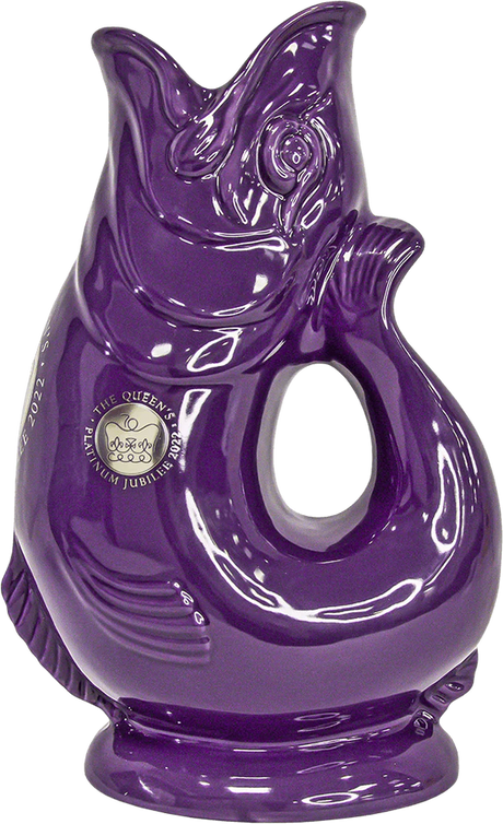 The Gluggle Jug Classic Made in Europe is a glossy, purple, fish-shaped pitcher with a handle, featuring an emblem and text for The Queen’s Platinum Jubilee 2022—a standout piece of British tableware.