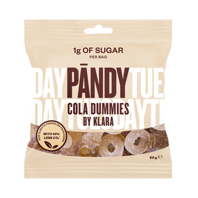A beige packet of Pandy Sugar Free Sour Cola Dummies candy highlights Scandinavian confectionery innovation, containing only 1g of sugar per bag and boasting a 40% reduction in CO2 emissions.