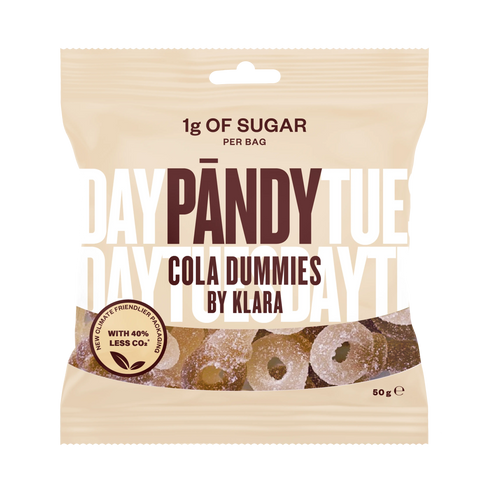 A beige packet of Pandy Sugar Free Sour Cola Dummies candy highlights Scandinavian confectionery innovation, containing only 1g of sugar per bag and boasting a 40% reduction in CO2 emissions.