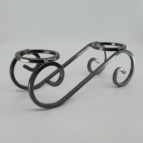This Danish Iron Candleholder features two Leif glass cups for ball candles, showcasing black metal craftsmanship with a swirled design against a plain white backdrop.