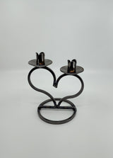 The Danish Iron Taper Candleholder, with a large heart design, elegantly holds two taper candles.