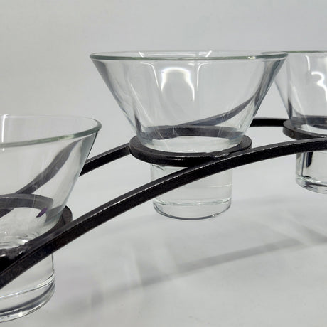The Danish Iron Arched Candle Holder, featuring four Leif cups, elegantly displays glass candle holders against a plain background.