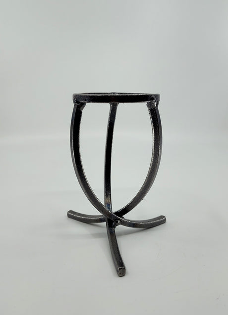 A Danish Iron candle holder with three crossed legs and a circular top in Leif Cup style, showcased on a plain white background.