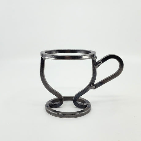 The Danish Iron Coffee Cup candle holder has a minimalistic wireframe style with a round base and handle, and includes a Leif Glass Cup for ball candles against a plain white background.