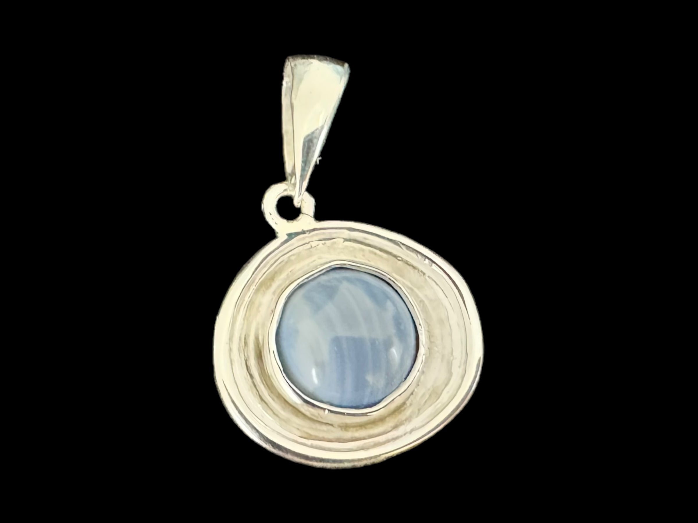 The Eira Silver pendant, crafted from .925 silver, showcases a captivating Swedish Blue stone at its center against a black background.