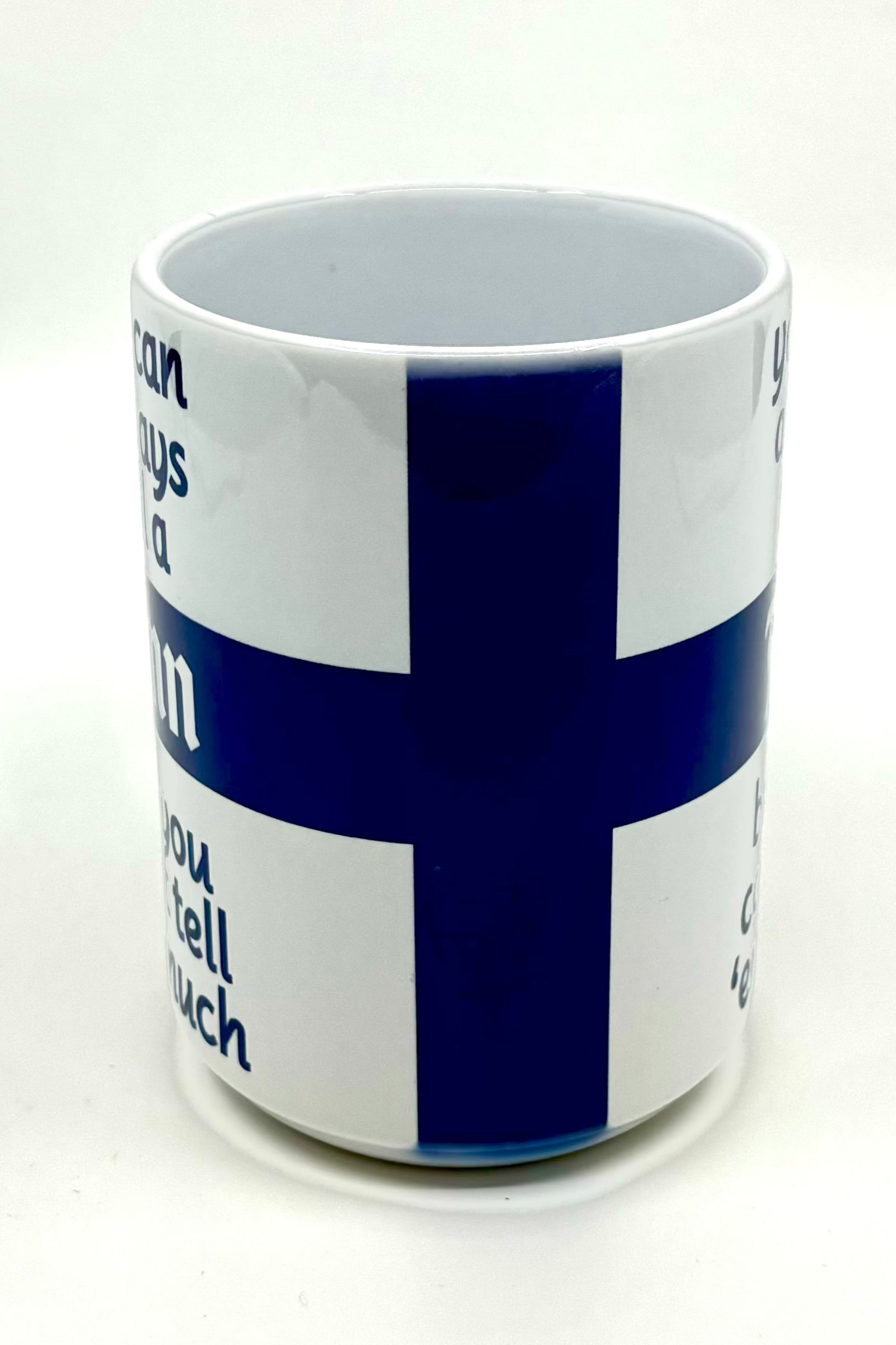 15 oz white mug showcasing a blue Nordic cross design with the partial text "You Can Tell a Finn.