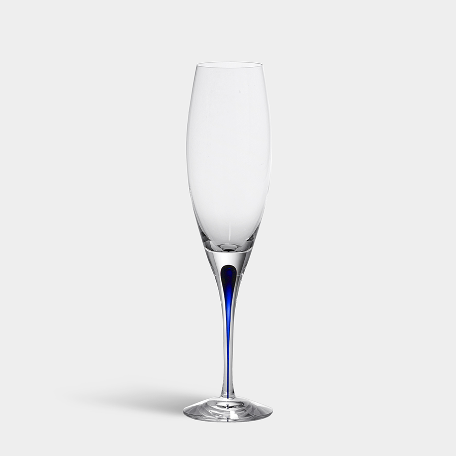 Against a plain white background, the Orrefors Intermezzo Blue Flute 7oz by Erika Lagerbielke stands elegantly with its slim blue accent on the stem.