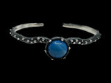The Freja Thin bracelet features an oxidized silver textured band with a captivating Swedish Blue ball at its center.