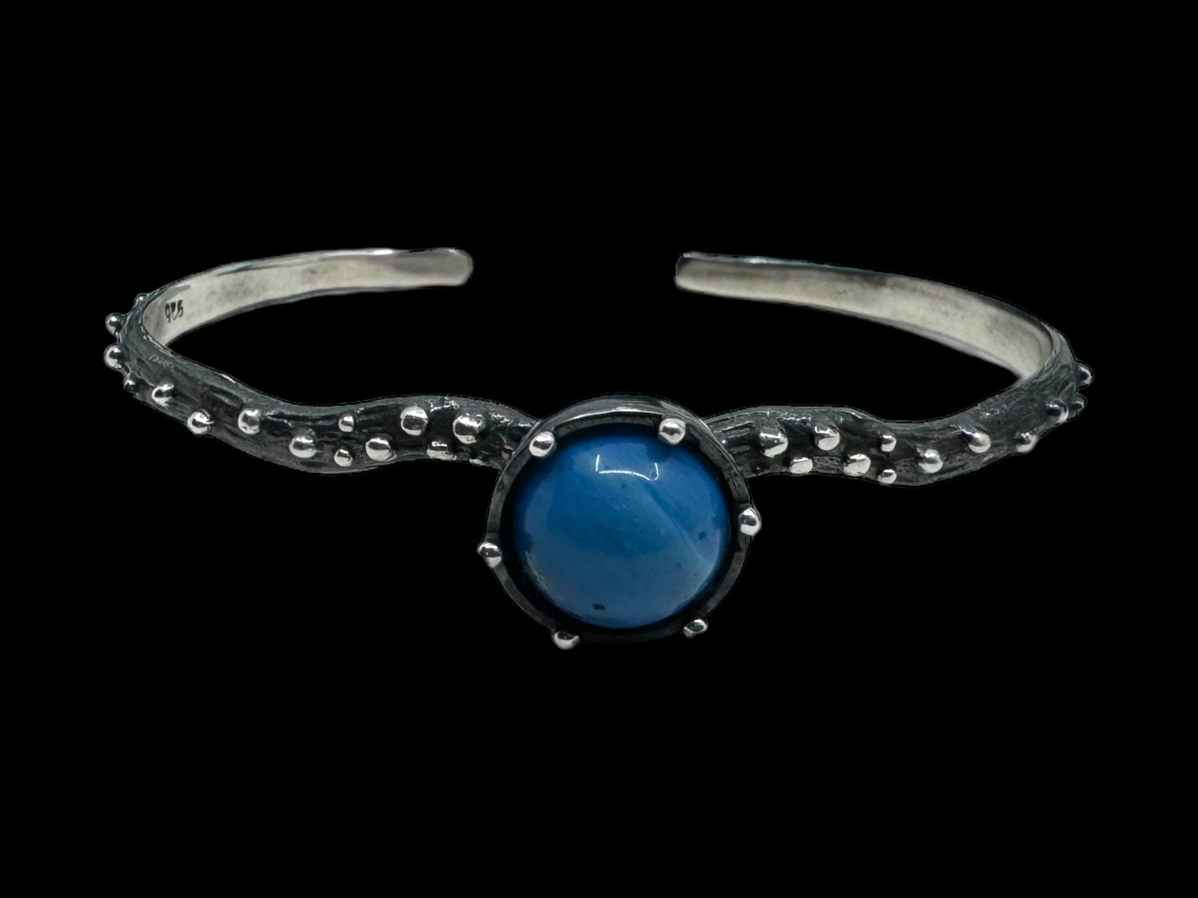 The Freja Thin bracelet features an oxidized silver textured band with a captivating Swedish Blue ball at its center.