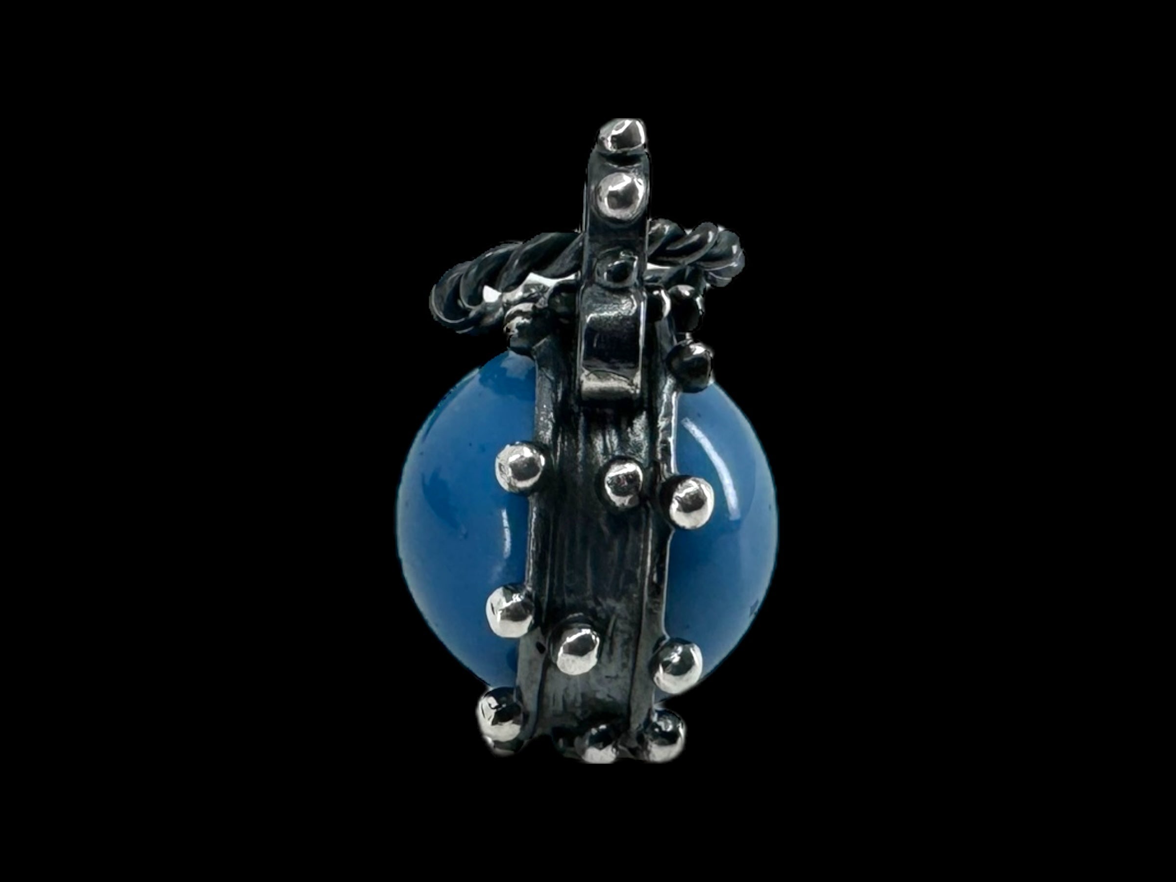 The "Freja - Swedish Blue" pendant features a blue round orb encased in a detailed, metallic gothic-style claw mount crafted from oxidized silver and adorned with small spherical rivets.